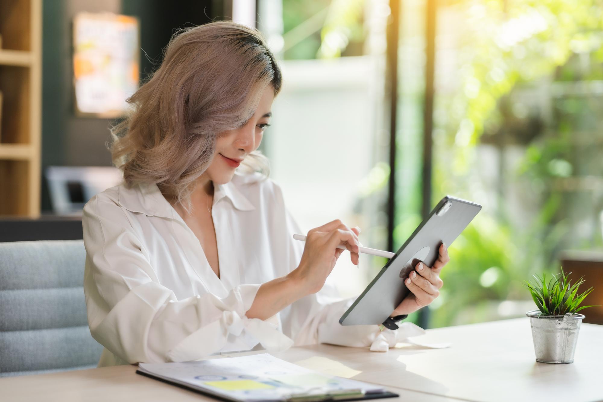 Beraterin erklärt Finanzplan an Tablet